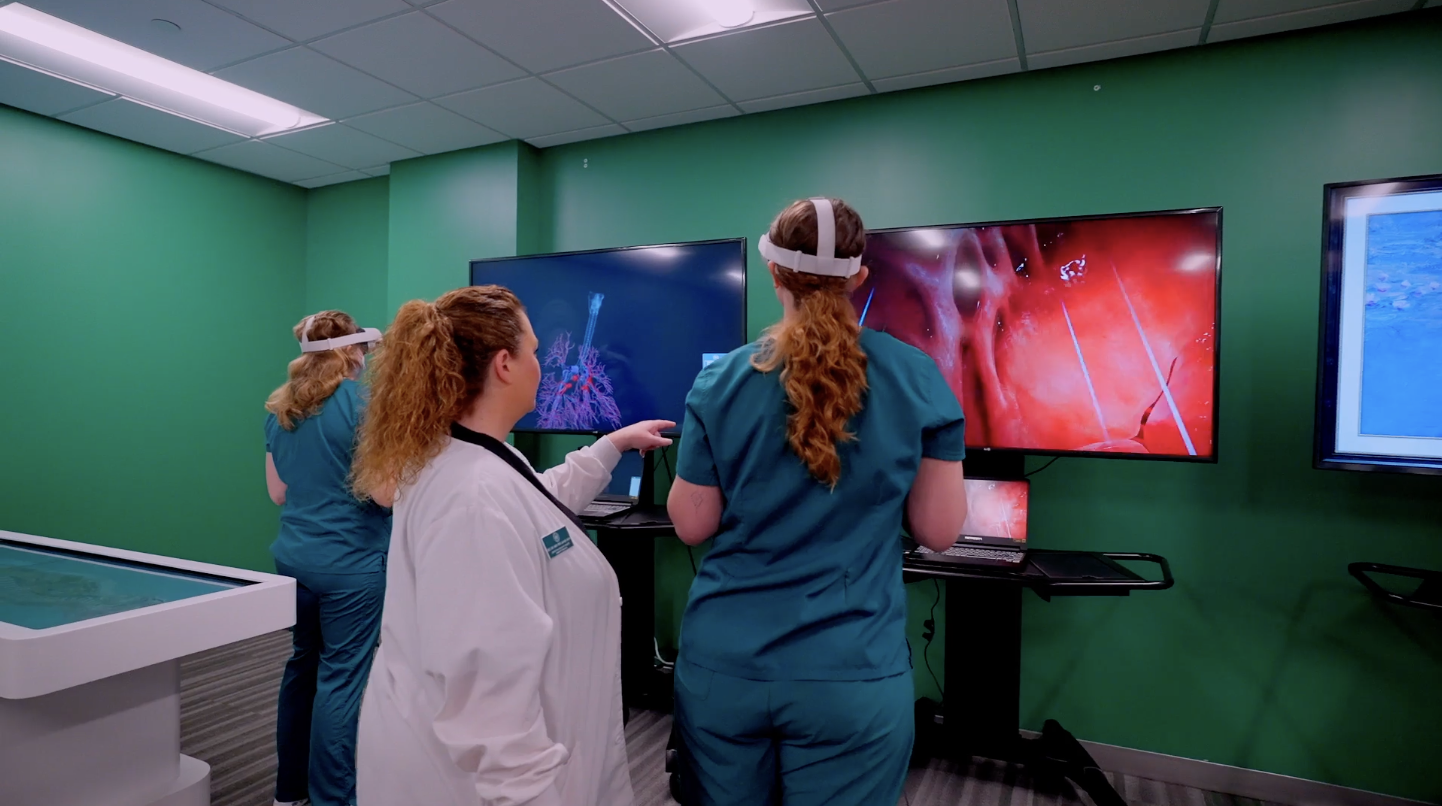 Nursing student using VR simulation with nursing instructor