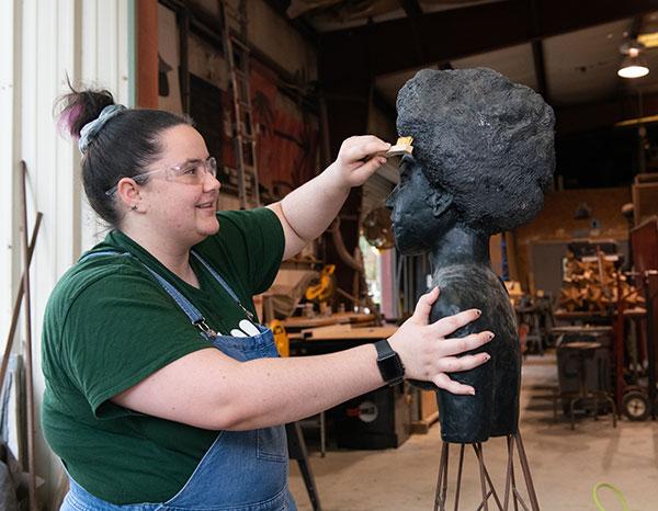 A student working on her sculpture in the studio.