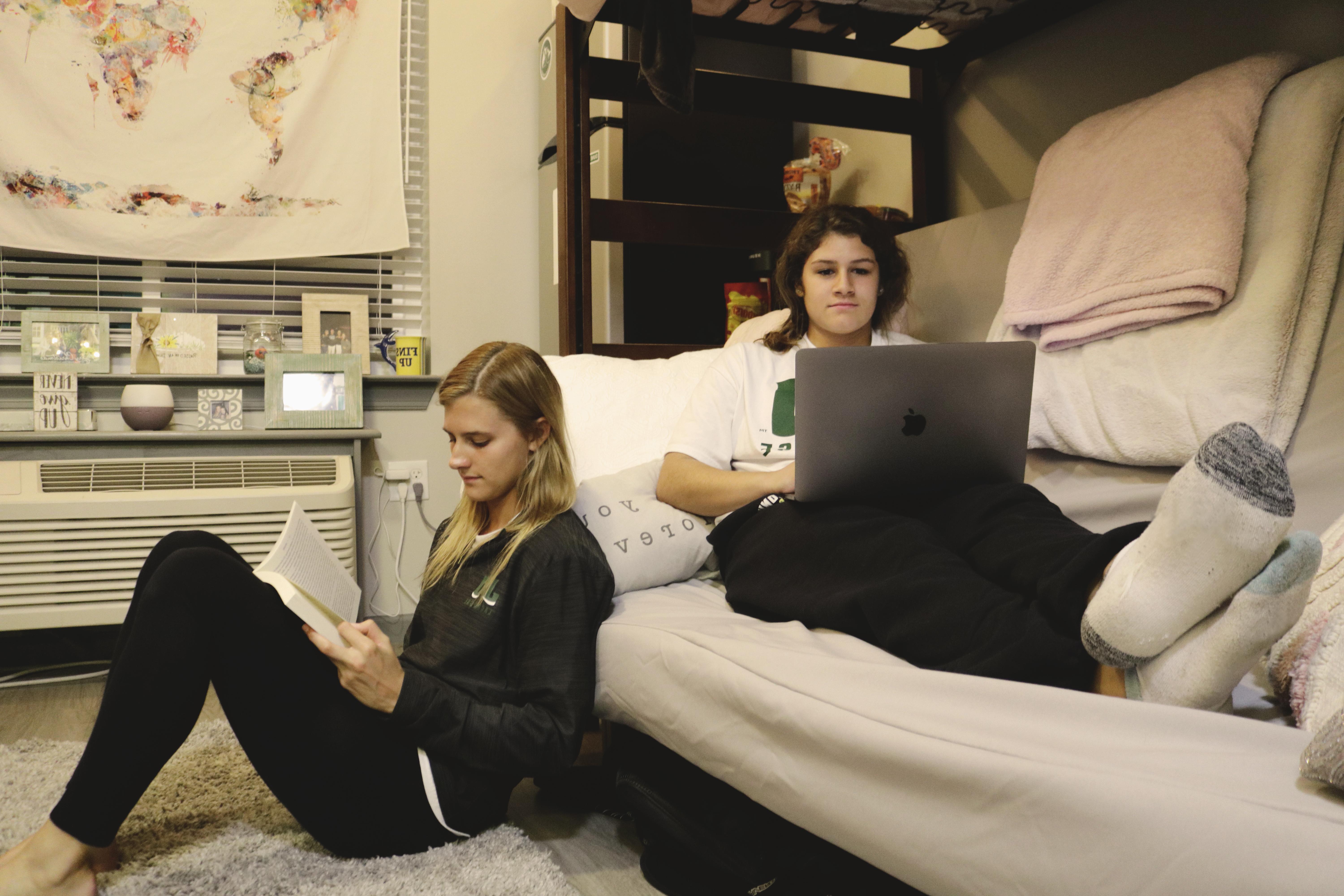 Students sitting inside dorm room