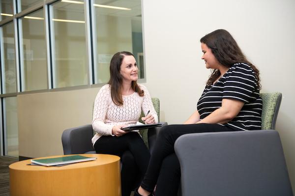 A mental health Nurse Practitioner talking to a patient.